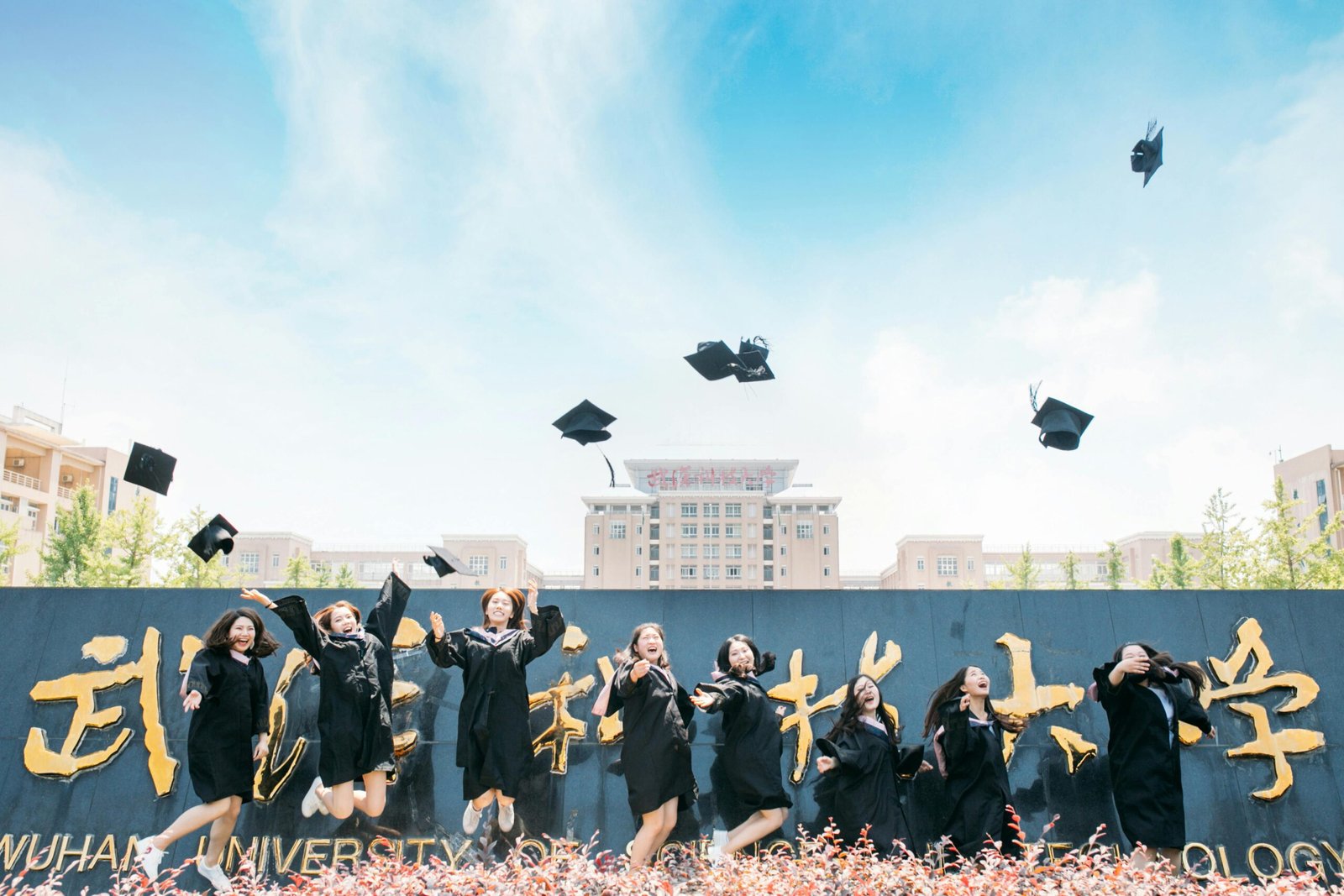 Graduates celebrate their success by tossing caps at Wuhan University, China.